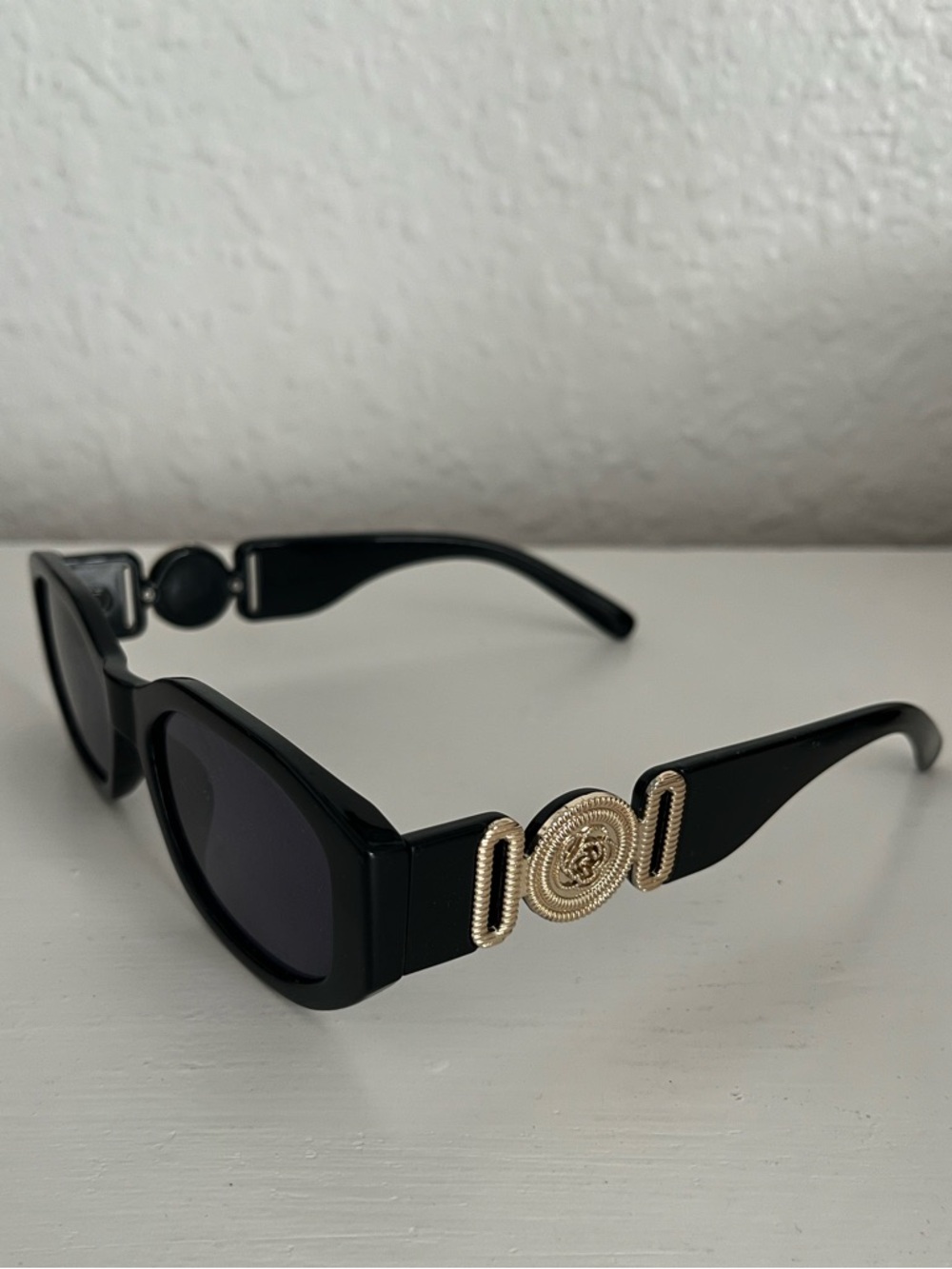 Black Sunglasses with Gold Medallion Accent